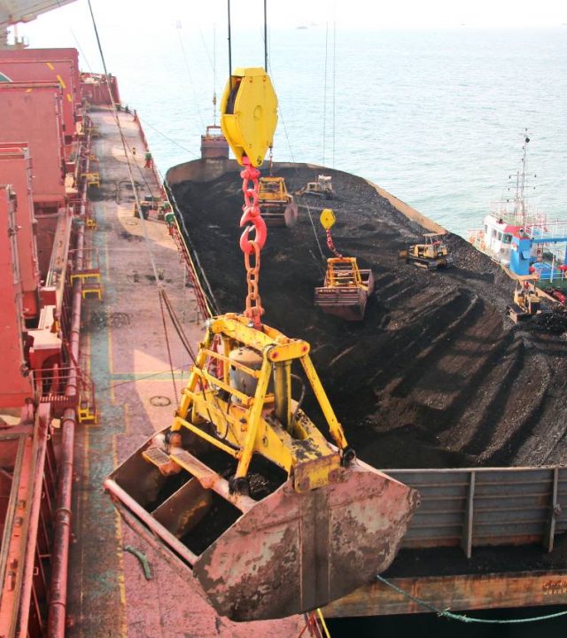 Ivan Kuzkin Loading coal from cargo barges onto a bulk carrier using ship cranes and grabs at the port of Samarinda, Indonesia.